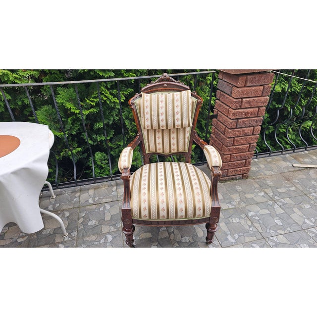 19th-century carved armchair with armrests and casters. Dimensions: height 102 cm, backrest width 62 cm, depth 63 cm, seat...