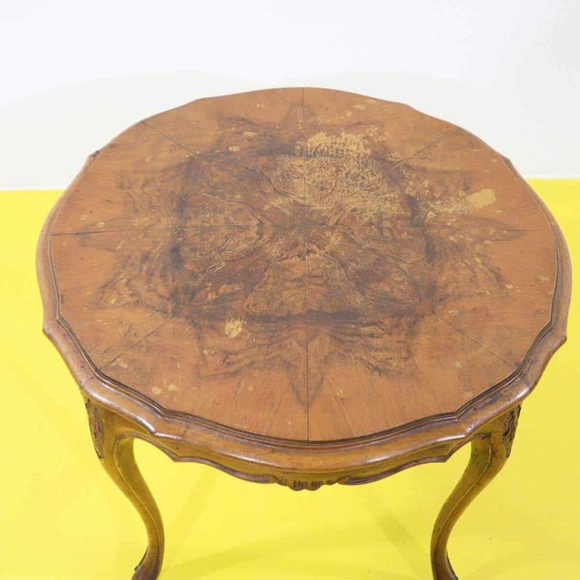 Round Louis XV style table made of walnut with a burl top.