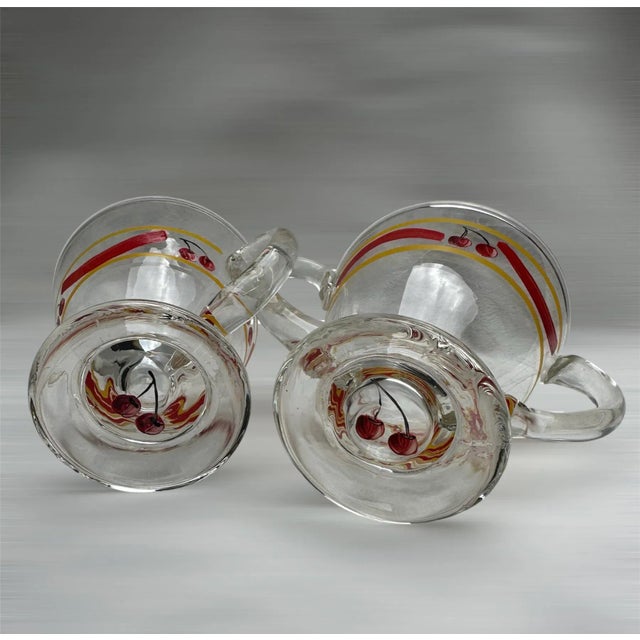 Hand painted vintage transparent glass footed cream and sugar set. Excellent condition of yellow banding, red swoops and...