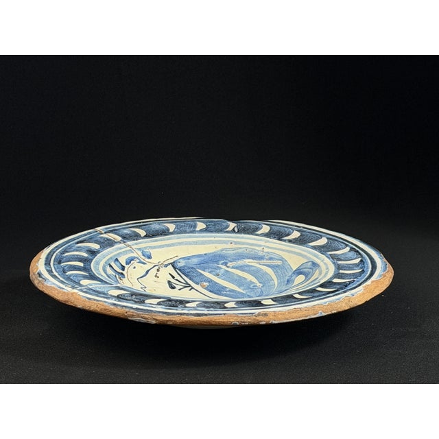 Rare 17th-century Catalan blue and white tin-glazed earthenware plate, produced in Catalonia, Spain. The plate features a...