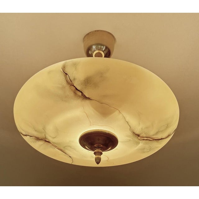 Art Deco pendant lamp with an amber glass shade with darker green and butterscotch veins and patches, brass canopy, finial...