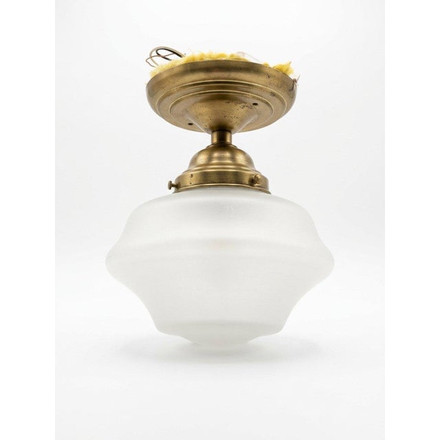 This compact semi-flush ceiling light would work beautifully in a dressing room or walk-in closet, especially near a...