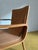 This refined vintage Danish armchair from the 1960s in fine teak represents the Scandinavian interpretation of the...