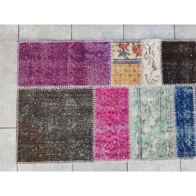 This is a vintage Turkish Oushak rug from the Mid 20th Century. The piece was hand-knotted.