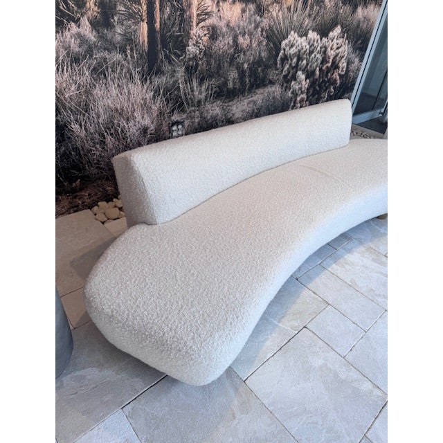 Elevate your living space with this striking curved cream-colored sofa, an embodiment of contemporary luxury and comfort....