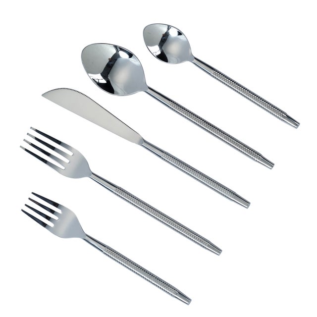 Sleek stainless steel meets subtle ribbed detailing in this five-piece flatware set designed for one complete place...