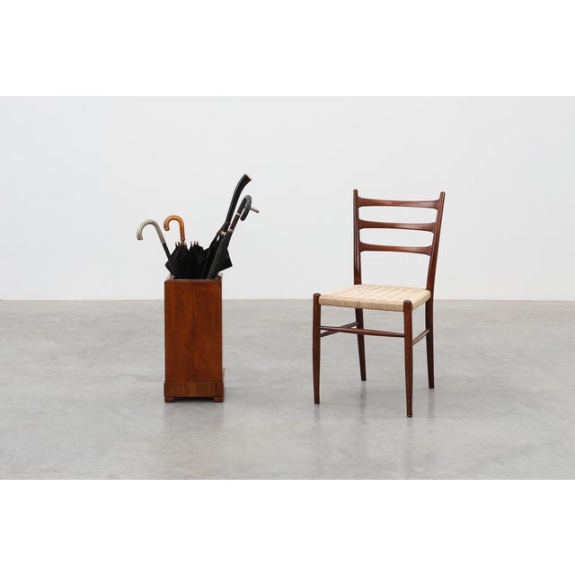 A refined Italian Art Deco umbrella stand from the 1920s, crafted in warm‑toned wood with a clean, architectural...