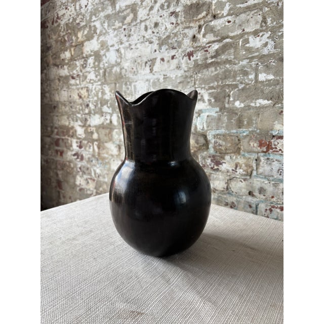 Striking contemporary ceramic vase in a rich chocolate brown glaze with an elegant sculptural silhouette. Featuring a...