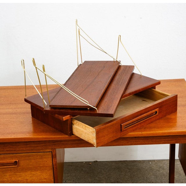 Single wall unit with 3 individually hanging sections. 1 large shelf, smaller shelf and compact desk or drawer section....