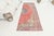 This is a vintage Turkish Oushak rug from the Mid 20th Century. The piece was hand-knotted.