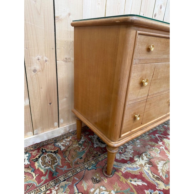 A 1960s double-bodied chest of drawers, featuring six drawers arranged in two columns of three, resting on tapered, turned...
