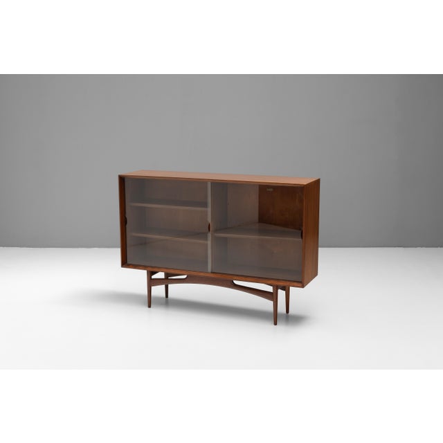 Mid-Century bookcase by Dalescraft furniture. Solid teak with two original glass sliding doors. Re-polished. U.K circa...