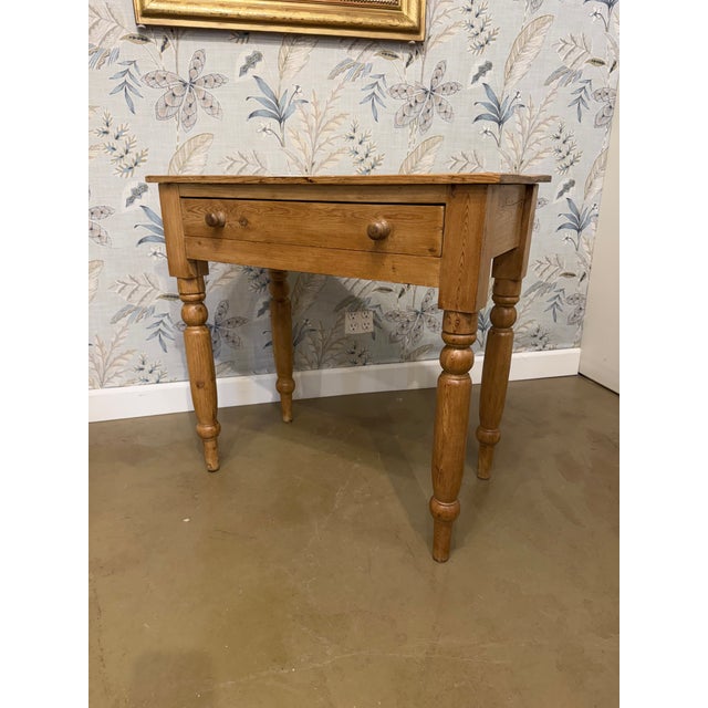 This is a great little English pine side table or small desk with large drawer resting on four lovely turned legs. The...