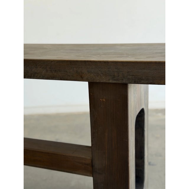 W65 D20 H30 This contemporary console features a bold sculptural design through a thick slab top and geometric cut out...