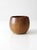 This vintage handmade studio pottery bowl features a rounded form and a warm glaze that transitions from rich brown to...