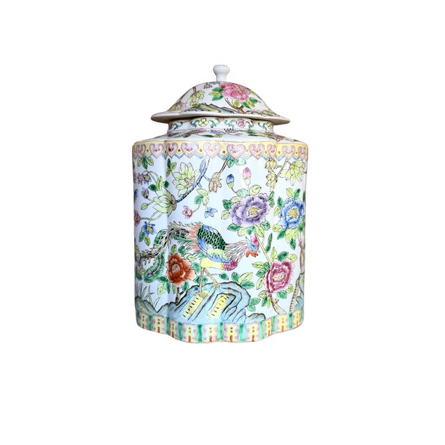 This richly detailed chinoiserie ginger jar features a vibrant hand-decorated scene of a stylized phoenix bird perched...