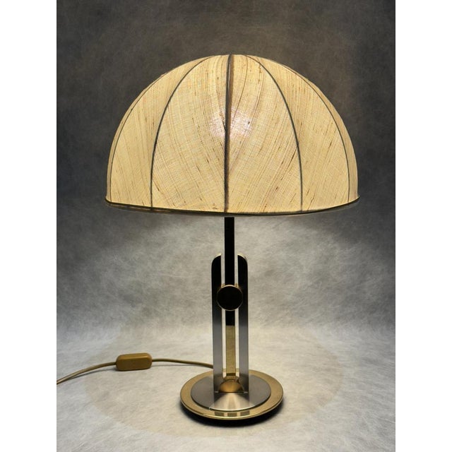 Elegant German table lamp in the opulent Hollywood Regency style, produced in the 1960s–1970s. The body combines gold-tone...