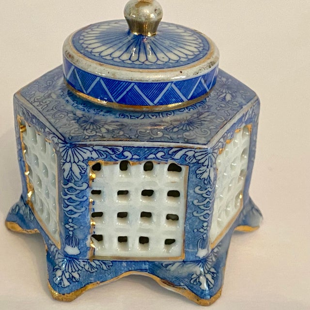 Wonderful porcelain blue, white with gold accents cricket cage inkwell. Features a hexagonal shape with lattice sides...