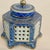 Wonderful porcelain blue, white with gold accents cricket cage inkwell. Features a hexagonal shape with lattice sides...