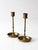 Pair of mid-century brass candlesticks featuring slender turned stems, engraved floral drip pans, and a warm aged patina....