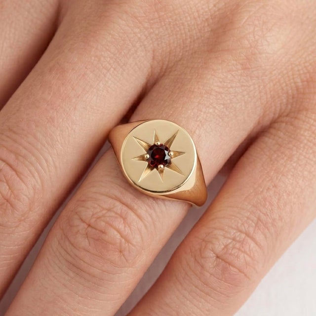 Bold, elegant, and timeless, this Garnet Starburst Signet Ring is designed to make a lasting impression. Crafted in a rich...