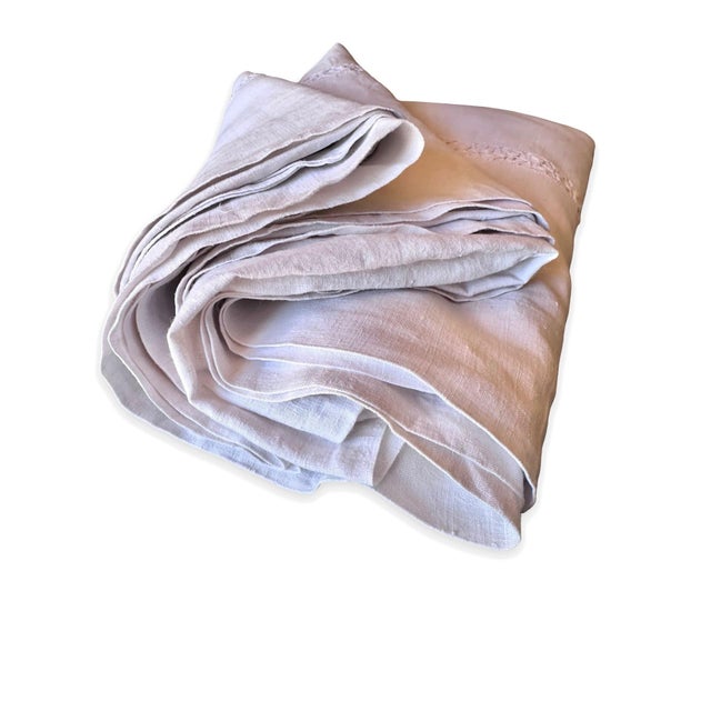 An exceptionally beautiful antique French fine linen sheet distinguished by an extraordinary band of handworked floral...
