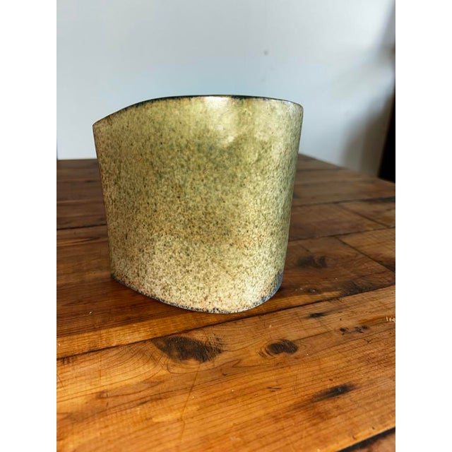 Add a touch of organic artistry to your space with this unique handcrafted ceramic piece, which functions beautifully as...