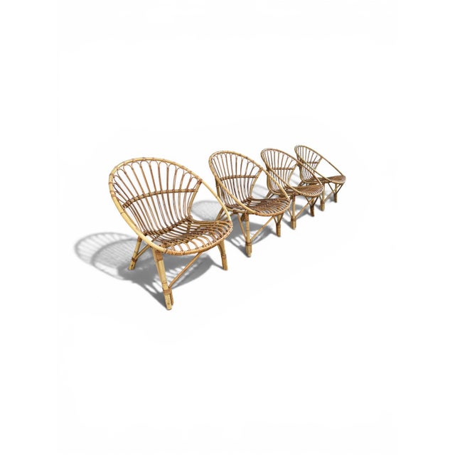 Superb garden furniture set comprising four rattan armchairs, a rare original edition circa 1955, originally from a...