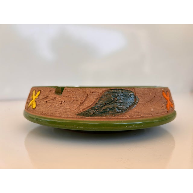 Mid Century Italian ceramic ashtray attributed to Bitossi. Predominantly glossy green in color with earthen clay around...