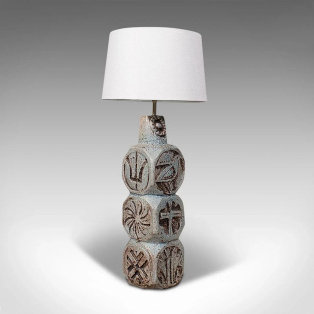 This is a vintage table lamp. An English, ceramic side light in the manner of Troika, dating to the late 20th century,...
