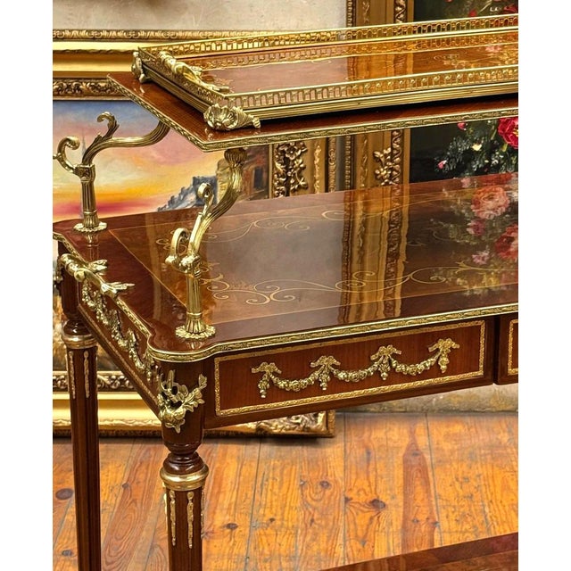 Make a sophisticated statement with this French Louis XVI-inspired serving table, crafted in wood with an elegant polished...
