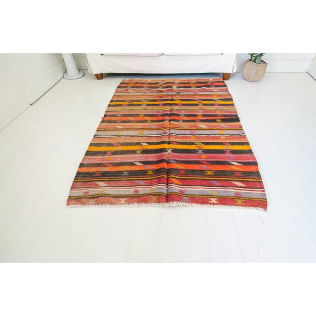 This is a vintage Turkish Oushak rug from the Mid 20th Century. The piece was hand-knotted.