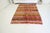 This is a vintage Turkish Oushak rug from the Mid 20th Century. The piece was hand-knotted.