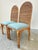 Pair of vintage wicker dining chairs with tall arched backs and finely wrapped frames. Elegant proportions with sculptural...