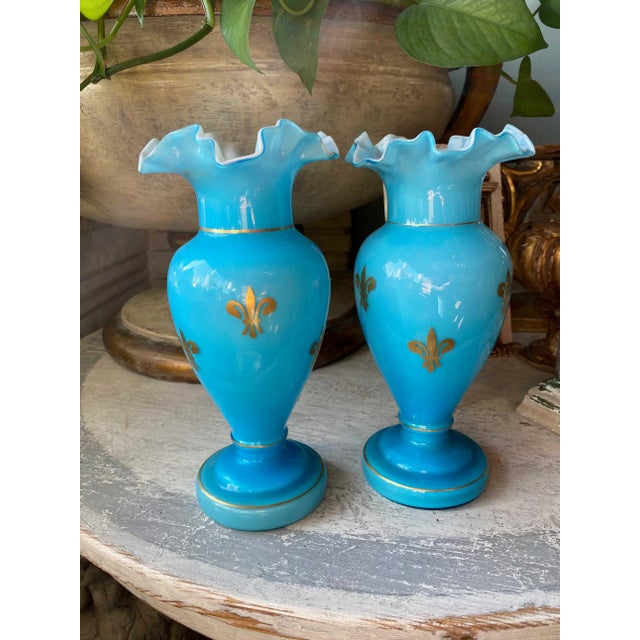 A pair of French blue vases with gilt fleur de lis. These circa 1880 vases are stunning with their scalloped rim. They are...