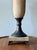 Vintage neoclassical table lamp featuring a textured faux stone finish, bronze-tone metal accents, square plinth base with...