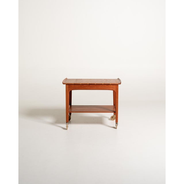 Teak serving trolley by Yngvar Sandström for Seffle Möbelfabrik, 1950s/1960s. Tray-shaped top with raised ends, drawer,...