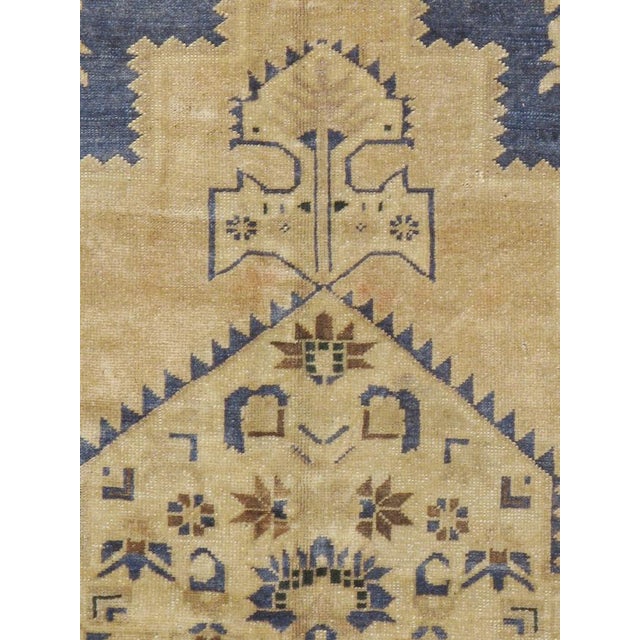 This Mid-20th century Turkish Oushak carpet presents a softly balanced composition centered by a stepped geometric...