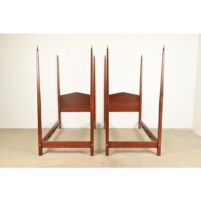A gorgeous pair of Federal or Georgian style carved walnut twin size poster beds In the manner of Baker Furniture By...