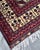 The ivory star lattice of this hand-knotted Afghan Turkmen rug reads like a constellation against a deep navy ground....