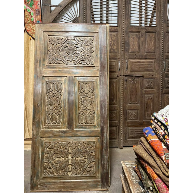 Elevate your home with this ornate vintage carved barn door, handcrafted from reclaimed wood and infused with old-world...