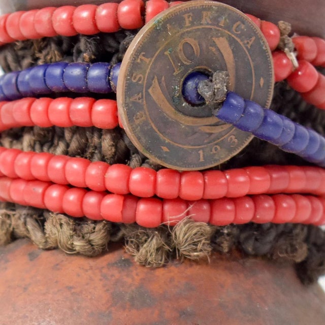 The Nyamwezi Beaded Fertility Doll Gourd with Shells from Tanzania is a stunning representation of fertility and...
