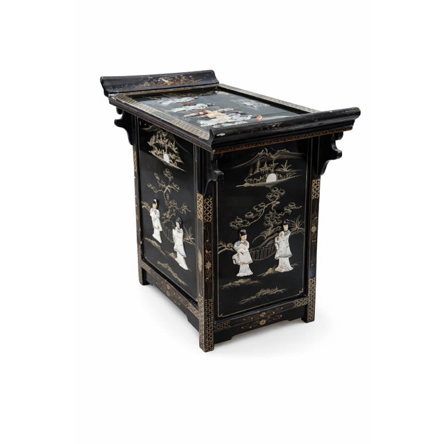 Beautiful vintage Asian black lacquer cabinet featuring intricate raised figural scenes and detailed landscape motifs...