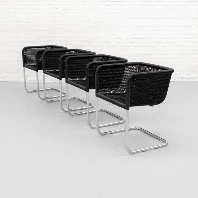 Set of four D44 armchairs, designed by Axel Bruchhäuser for Tecta in the 1980s. Black woven shells wrap gently around the...