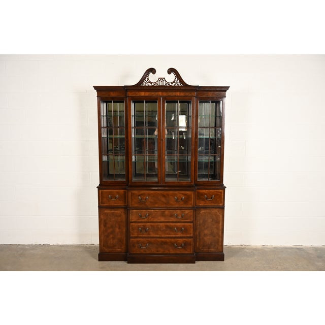 A gorgeous Georgian or Chippendale style lighted breakfront bookcase or dining cabinet with drop front secretary desk By...