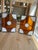 This pair of vintage stained glass panels features a bold geometric design crafted with rich amber-colored textured glass...