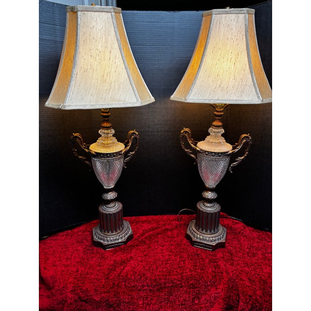 Exceptional and highly distinctive pair of French Neoclassical/Empire-style urn-form table lamps featuring substantial...