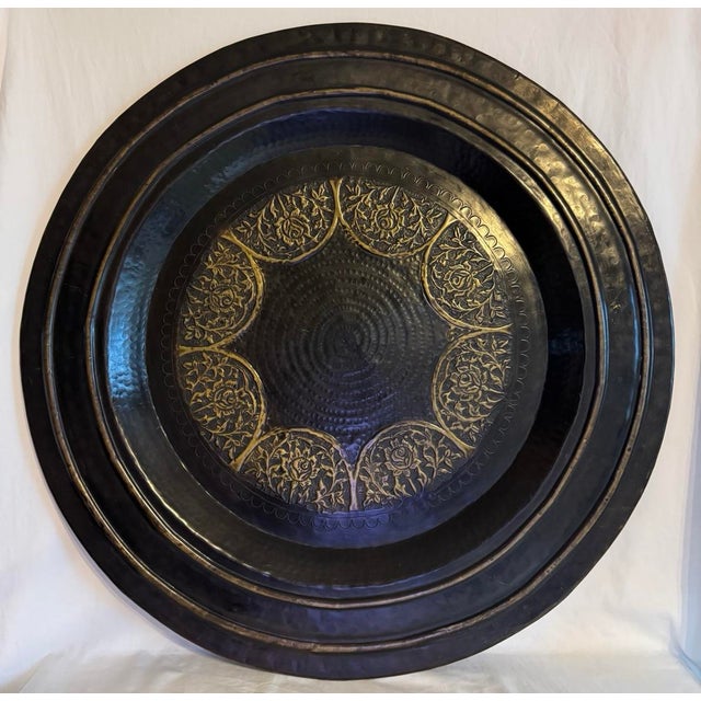 Large 30” hammered and repousse brass Persian style tea tray tabletop tray. The tray has a dark enameled finish that...