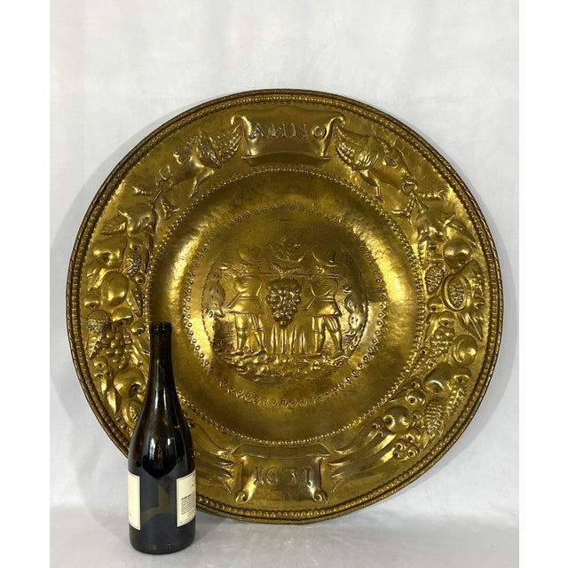 A gleaming, unusual and large brass tray or wall hanging featuring a harvest theme that was made in England. We think it...