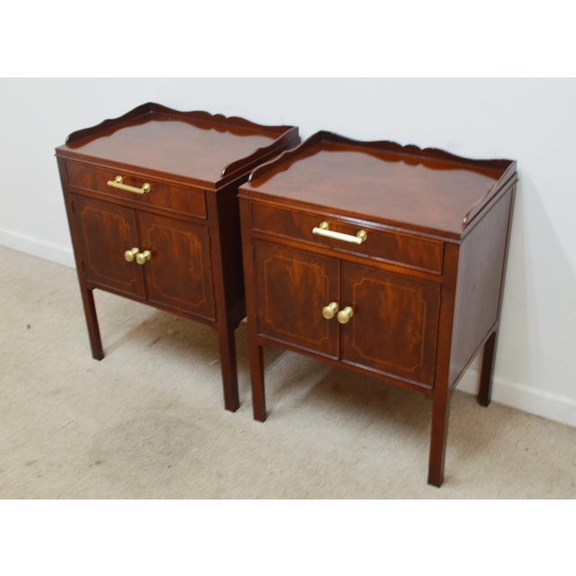 Pair of Nightstands by Baker. Store item #521. They feature mahogany inlaid wood and dovetailed drawers.